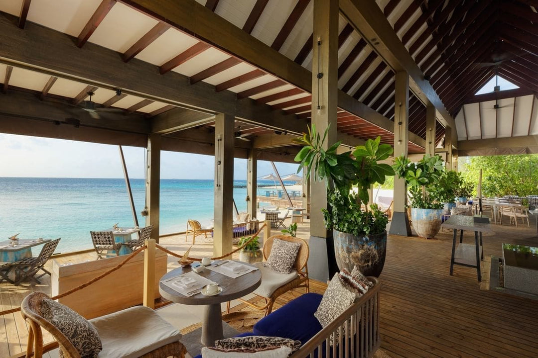 Open-air dining at The Edge at Grand Park Kodhipparu, tables looking out over the ocean