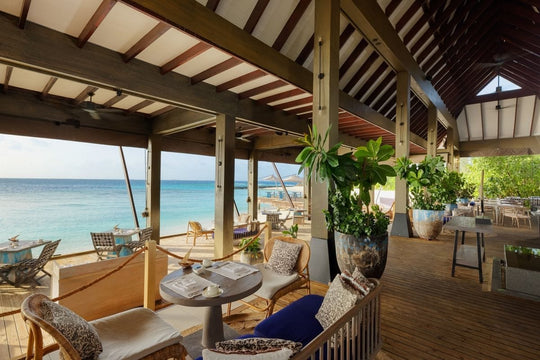 Open-air dining at The Edge at Grand Park Kodhipparu, tables looking out over the ocean
