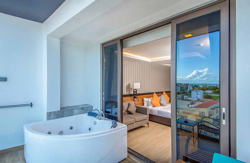Room at Triton Prestige with a jacuzzi bath by the balcony door