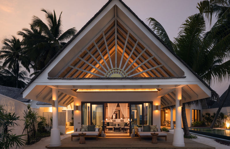 A beach villa lit at dusk at RAH GILI Maldives.