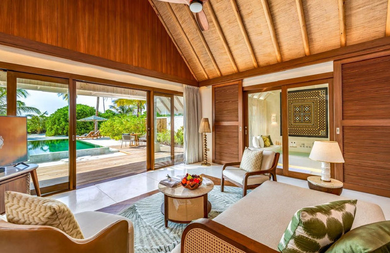 A bedroom opening to the pool at RAH GILI Maldives.