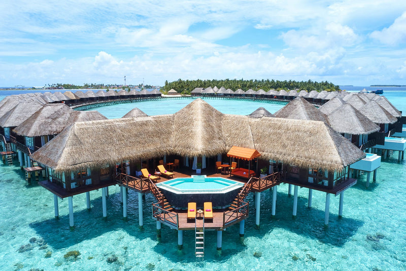 Sun Siyam Vilu Reef, Dhaalu Atoll — thatched overwater villas above the lagoon