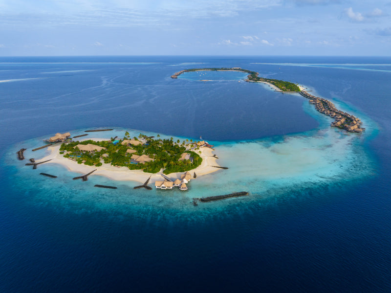 Waldorf Astoria Maldives Ithaafushi, South Malé Atoll: aerial view of the resort's islands, ringed by reef and deep blue sea