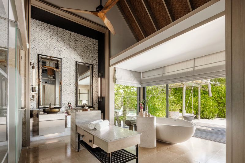 Waldorf Astoria Maldives Ithaafushi, South Malé Atoll: a Beach Villa bathroom with a freestanding bath and a garden view