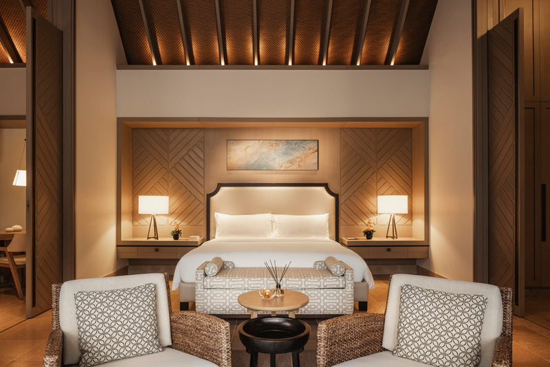 Waldorf Astoria Maldives Ithaafushi, South Malé Atoll: a Beach Villa bedroom with a king bed and two armchairs