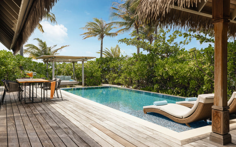 Waldorf Astoria Maldives Ithaafushi, South Malé Atoll: a Beach Villa pool deck with a dining table and a thatched swing daybed