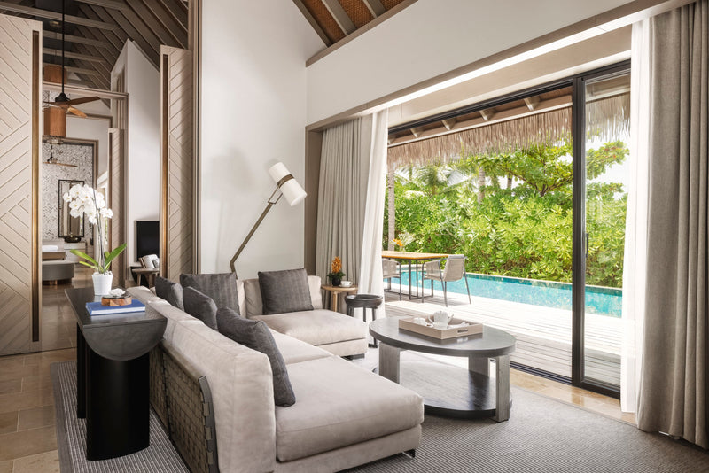 Waldorf Astoria Maldives Ithaafushi, South Malé Atoll: a Grand Beach Villa living room opening onto the pool deck