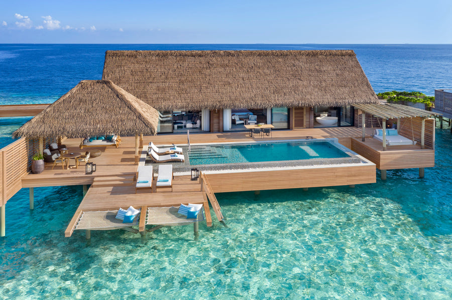 Waldorf Astoria Maldives Ithaafushi, South Malé Atoll: a Grand Overwater Villa with a large pool deck and steps into the lagoon