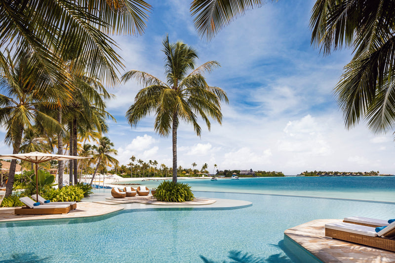 Waldorf Astoria Maldives Ithaafushi, South Malé Atoll: palm-lined infinity pool looking out across the lagoon