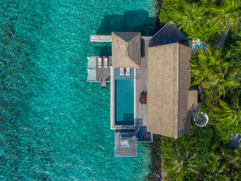 Waldorf Astoria Maldives Ithaafushi, South Malé Atoll: overhead view of a Reef Villa, its pool deck over the water and garden behind