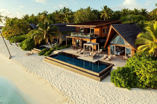 The St. Regis Maldives Vommuli, Dhaalu Atoll — Aerial of a two-storey beach residence with a long pool on white sand