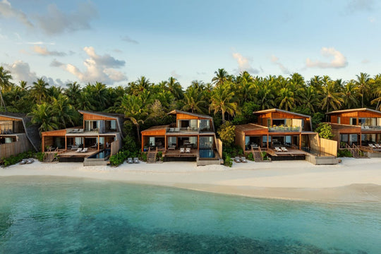 The St. Regis Maldives Vommuli, Dhaalu Atoll — Row of beach villas with private decks, seen from the water