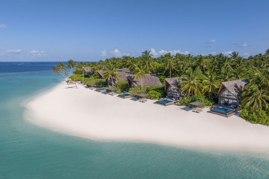 The St. Regis Maldives Vommuli, Dhaalu Atoll — Aerial along the shoreline, beach villas in a line behind a white sandbank