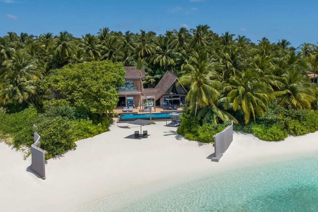 The St. Regis Maldives Vommuli, Dhaalu Atoll — Aerial of a villa set back among palms, with a sand spit in front
