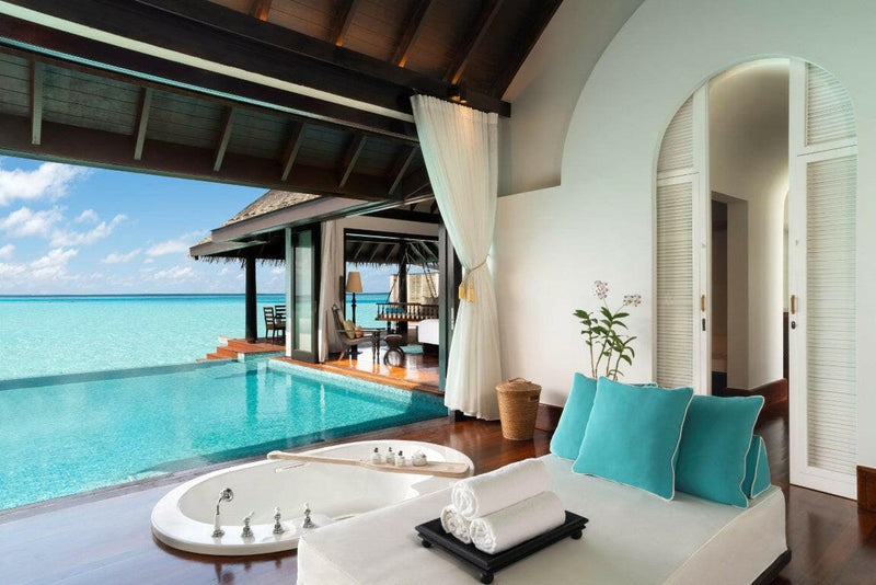 The bathroom of an Overwater Pool Villa at Anantara Kihavah Maldives Villas, the bath beside the pool and the open lagoon