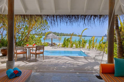 The deck of a Beach Pool Villa at Anantara Dhigu, private pool and thatched sun shade facing the sea