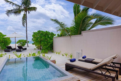 The private pool of a Beach Pool Villa at Brennia Kottefaru, palms and the sea beyond
