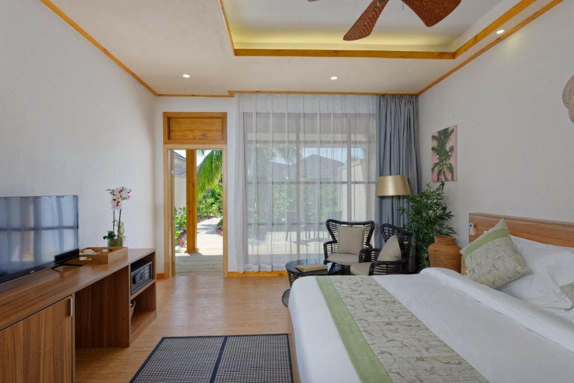 A Bougain Villa bedroom at Brennia Kottefaru, writing desk and doors opening to the garden
