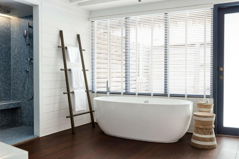 A freestanding bath in a Loft Water Villa at COMO Cocoa Island, set beside a shuttered window