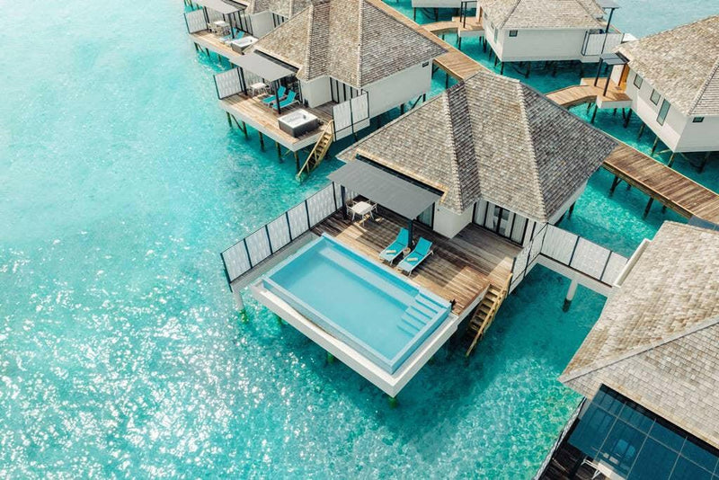 Nova Maldives from above, water villas with plunge pools stepping out across the lagoon.